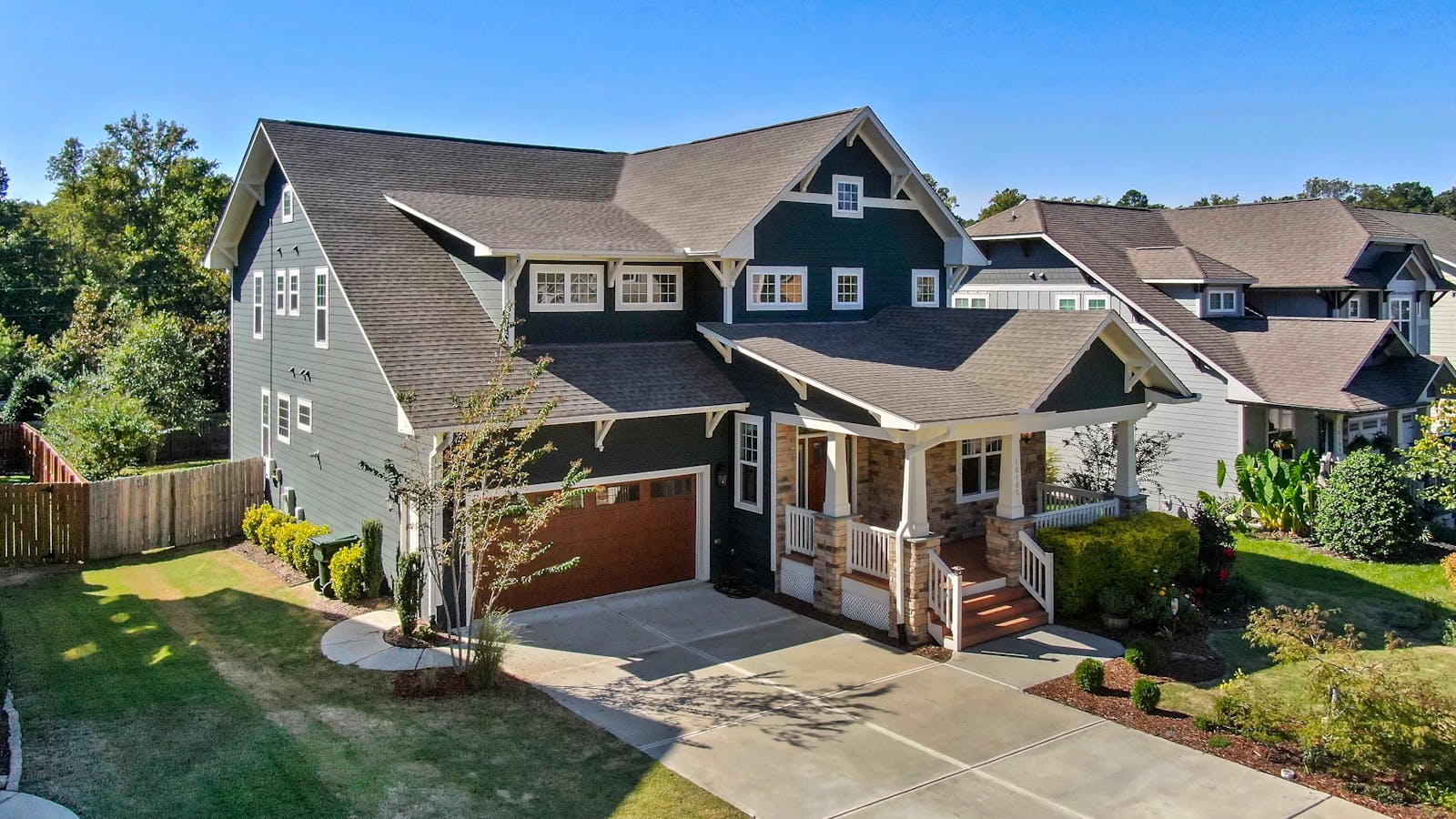 Craftsman-style home with prominent covered porch and deck details